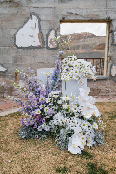 Wedding Ceremony with altar pedestals filled with lush floral arrangements designed by snapdragon bloom bar