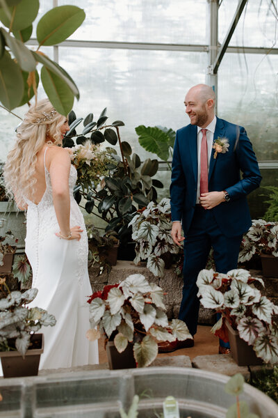 bride and groom in greenhouse