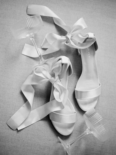 Elegant bridal shoes with ribbons with champagne glass