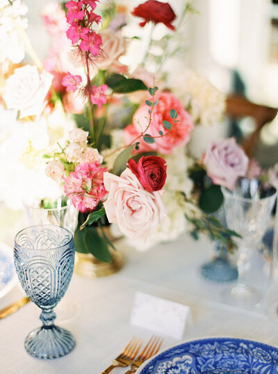 wedding reception florals tablescape with pink and colorful flowers