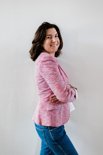 Andrea Shah, a copywriter smiling and standing sideways