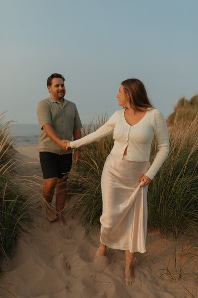 couple walking on beach at prince edward island for lifestyle photos