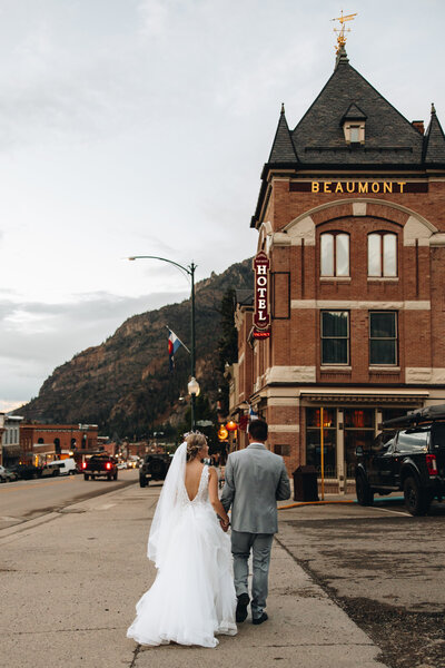 Couple walks back to their reception at the Beaumont Hotel in Ouray, Colorado.