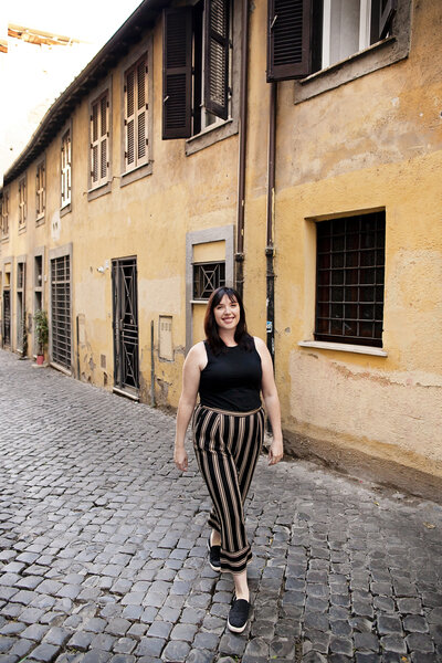 girl solo traveler on a cobblestoned street in Trastevere. Taken by Rome Travel Photographer, Tricia Anne Photographer