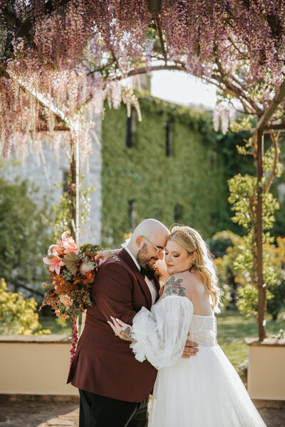 Couple sharing a magical moment on their wedding day in Tuscany’s rolling hills.