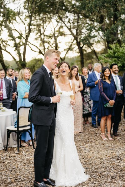 bride and groom celebrating wedding reception at medlock ames during toasts