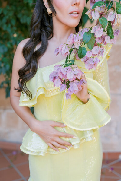 Fashion-inspired wedding detail photography with black bow heels and flowers by Emma Haidar.