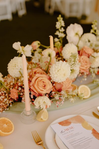 Wedding table setting with orange and peach accents