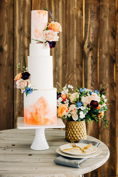 Cake and flowers on wedding reception table at Fox Fields in Red Lodge, MT
