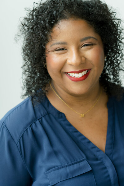 A close-up portrait of Mica McCook, smiling warmly at the camera. This image captures Mica’s genuine and friendly personality, making it an ideal representation of her approachable and engaging nature as a professional photographer.