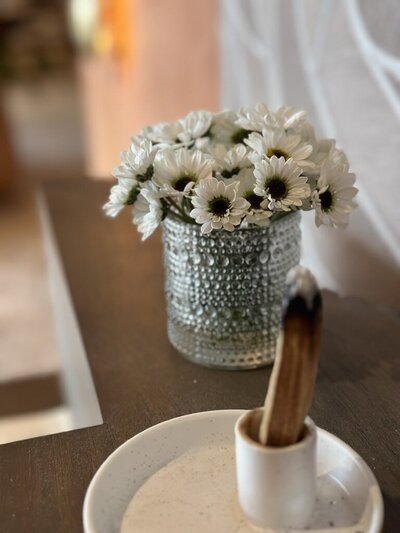 Palo santo with white blossoms, evoking peace, clarity, and energetic clearing in emotional healing work