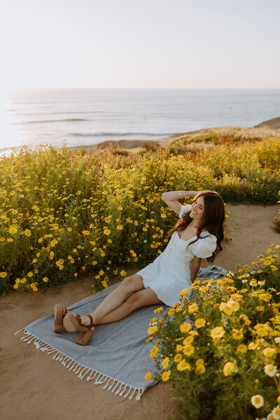 San Diego Senior Photo Shoot at Sunset cliffs point loma PLNU with spring superbloom wildflowers graduation