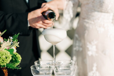 Bride and Groom pour champegne at their wedding at The Stables at Copper Ridge in Dension.