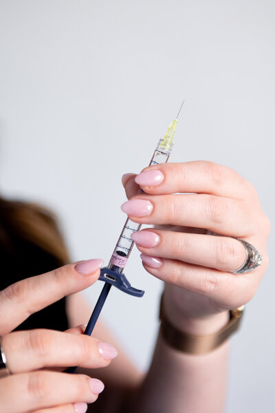 hands holding a syringe