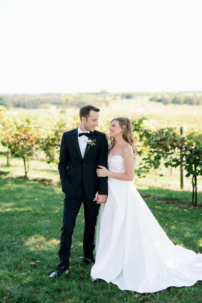 wedding photographers in minneapolis capturing bride and groom kissing in front of a tree