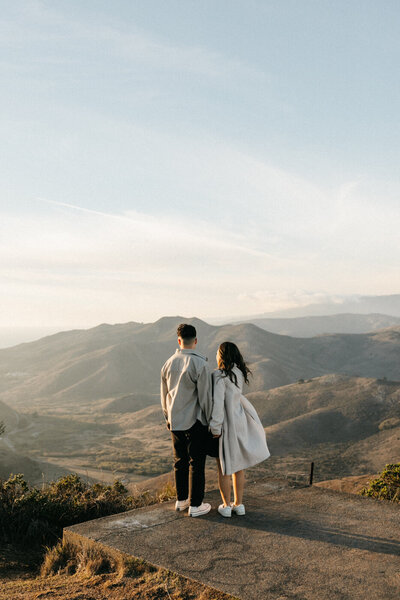 couple overlooking mountains and coastline in san francisco