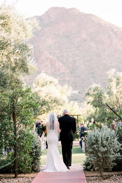 Bride walking down aisle during ceremony at El Chorro Wedding Venue