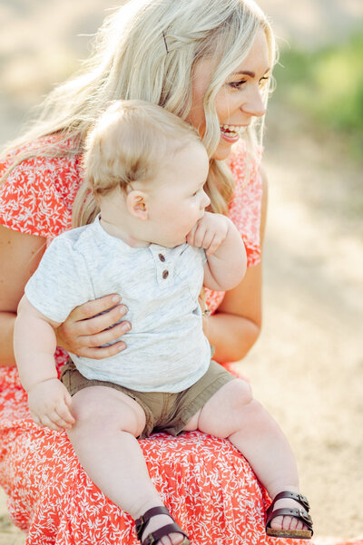 baby sits on moms lap