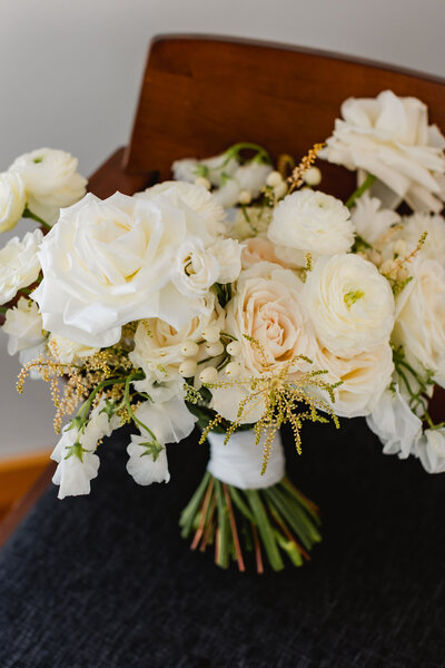 All white wedding bouquet with roses and ranunculus flowers