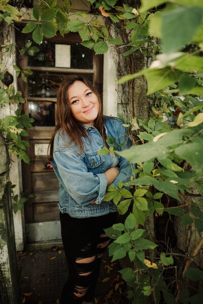 woman smiling leaning against a tree