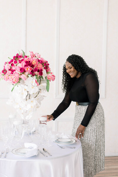 Woman smiling while setting up place setting