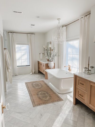 Marble floors, an oversized free-standing tub and his and hers vanities make the primary bathroom a luxury retreat