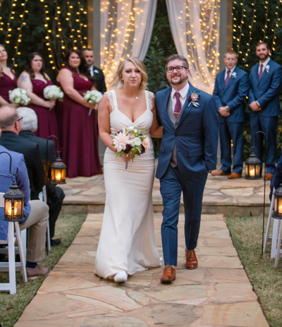 Bride and groom walking down the aisle hand in hand after their wedding ceremony, radiating joy and love as they begin their new journey together.