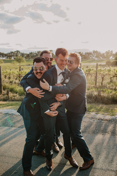Couple seperating in the moments after a piggyback ride, wife's arm still around husbands chest and both laughing