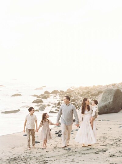 one of the best family photographers in san francisco ca with her family on the beach