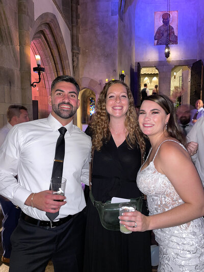 photographer with bride and groom