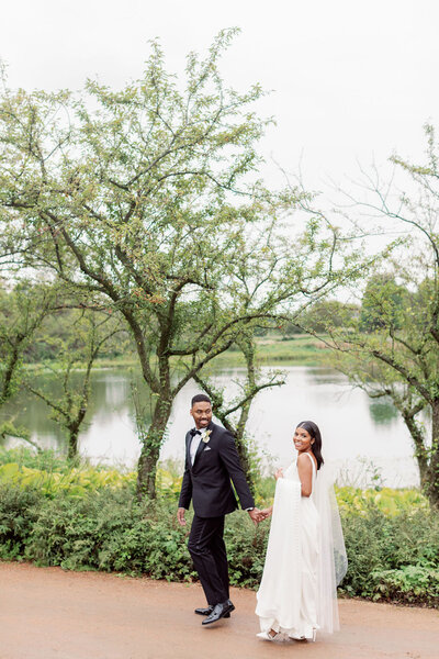 Bride and Groom walking through Luxury Chicago North Shore Garden Wedding Venue