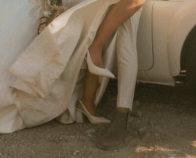 bride and groom shoes against a car