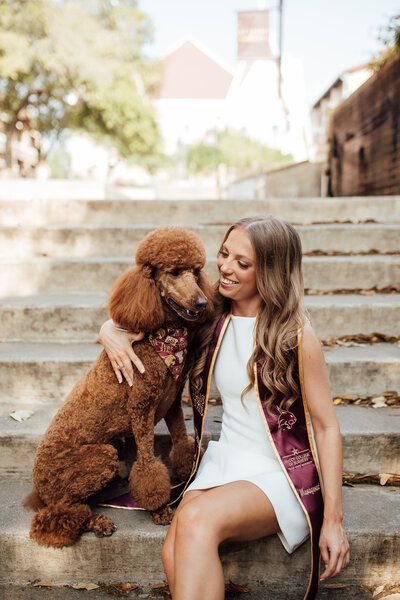 Girl poses with dog during senior photoshoot