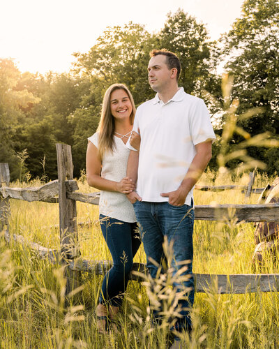 A couple looks into the distance during their couples session at Hudson Crossing in Schuylerville, NY.
