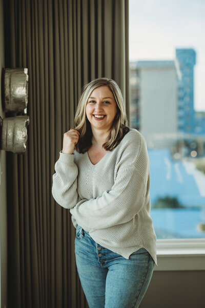 Blonde woman smiles inside beach house in Panama City Beach