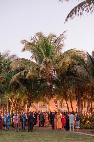 Wedding guests colorful cocktail hour at Lyford Cay Club Nassau Bahamas sailcloth tent wedding, Lindsey Whatley Photo, East Coast Documentary-style wedding photographer for the untraditional 