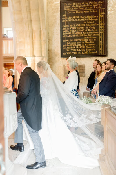 Bride and her father enter the church on her private estate wedding day in Scotland, planned by one of the UK's best wedding planners, Laura McCranor Events. Image by multi-award winning luxury wedding photographer uk, Jill Cherry Porter.