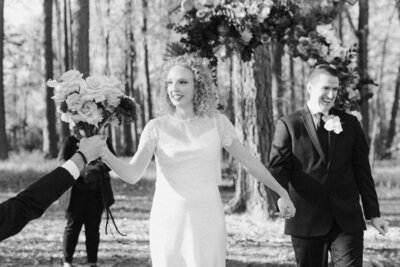 Bride and groom walk down isle after their intimate Richmond backyard wedding, captured in warm natural light by Editorial Wedding Co.