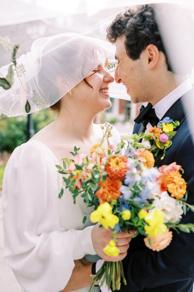 Bride and groom with colorful bouquet
