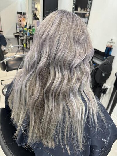 Image of client with long hair that has been fully dyed an ashy grey.
