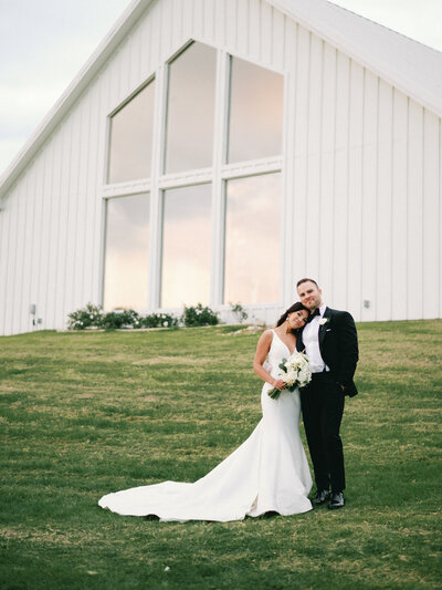 Bride and Groom smiling at The Farmhouse in Montgomery, Texas