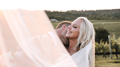 Husband kisses wife at vineyard wedding near Charlottesville, Virginia