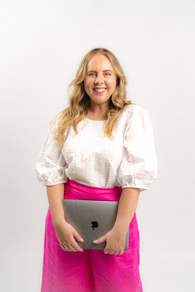 Amy Hart the Dubsado expert holding a disco ball and cocktail