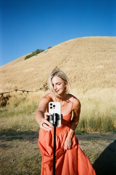 Jaiden looking at a book sitting in a chair