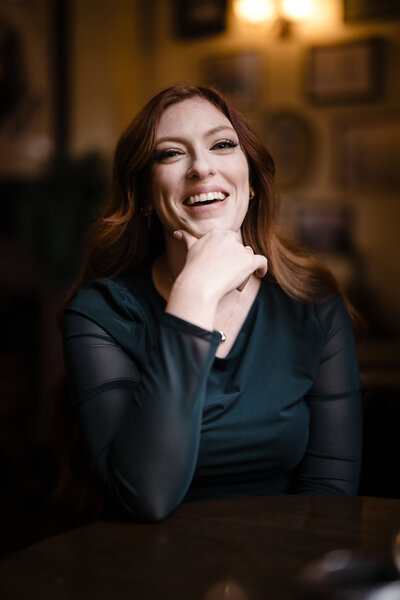 Image of Sarah Kenyon laughing wearing tan leather jacket