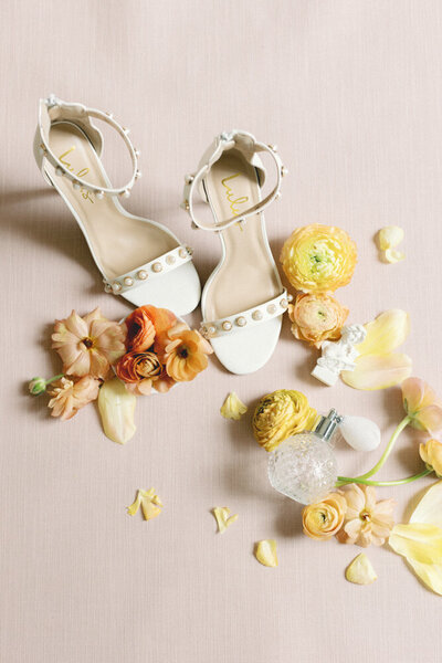 pink layflat with shoes and flowers