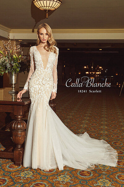 Sequinned lace A-line silhouette Illusion plunge V-neckline Luxurious matching cape Pocket detailing Cascading train