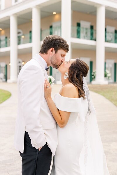 Sophisticated bride and groom kiss