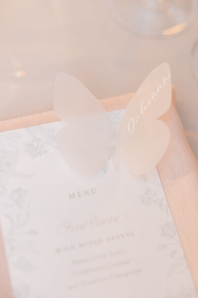 Vellum butterfly place card with white calligraphy on menu card for Hamptons wedding in  the Hamptons, New York