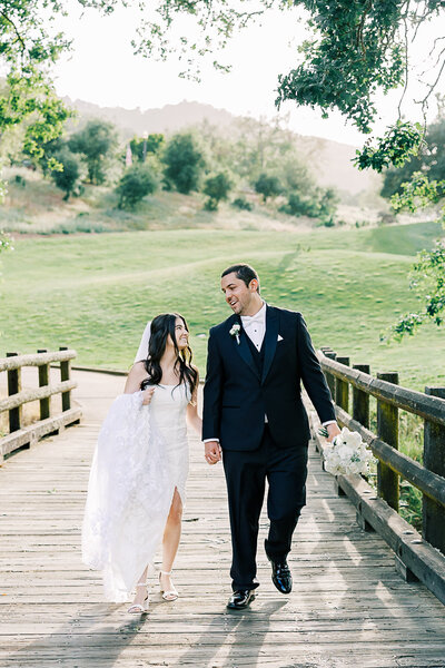Bride and groom celebrating their wedding day at Eagle Ridge Golf Course in Gilroy, California, with lush fairways and rolling hills in the background.